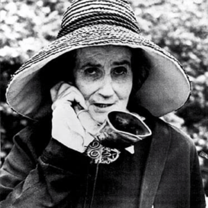 A photo from history of a woman holding phone close to her ear.
