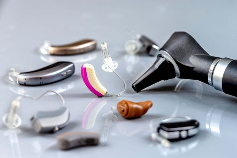 Close-up of various hearing aids and an otoscope used in hearing care for Deaf Awareness Week 2025.