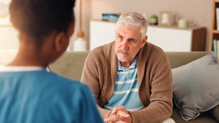 An elder man with a nurse